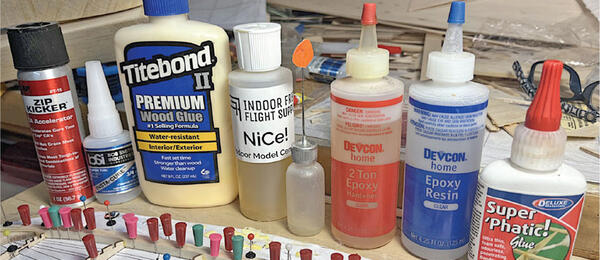 Glue bottles and woodworking supplies on a cluttered workbench.