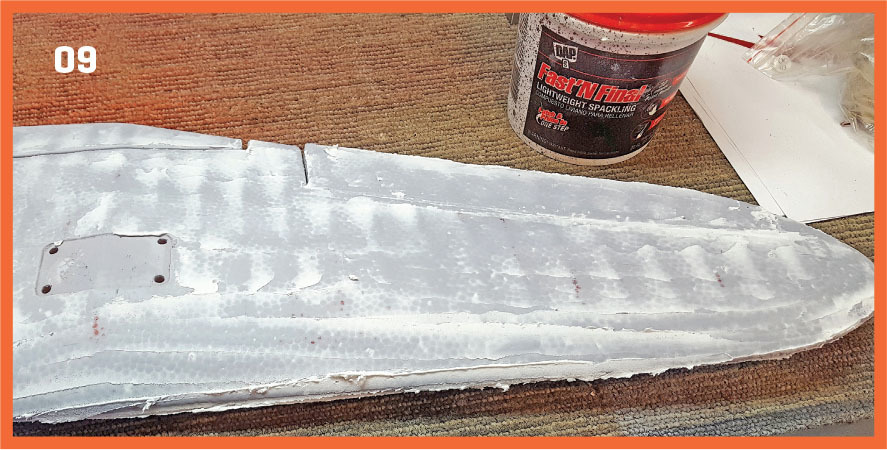 White fiberglass piece and spackle tub on a carpet, numbered "09".