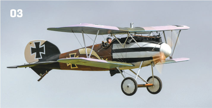 Vintage biplane in flight, featuring military insignia and the number "03."