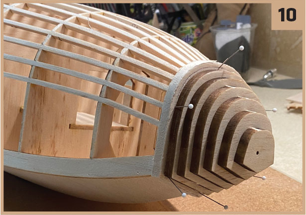 Wooden model ship under construction, framework with pins, labeled "10."