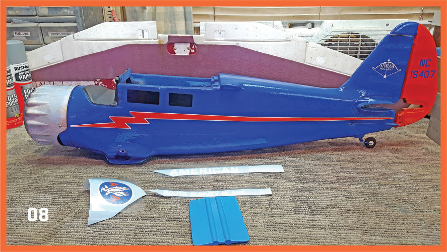 Blue and red model airplane parts with text "NC 18407" and "American" on decals.