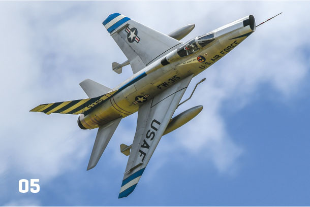 Fighter jet with "U.S. Air Force" and "USAF" markings flying against blue sky.