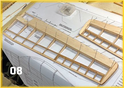 Model airplane wing frame on plans, number 08 in corner.