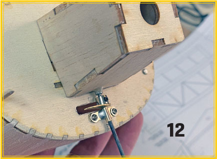 Wooden assembly with screws and number 12 in the corner.