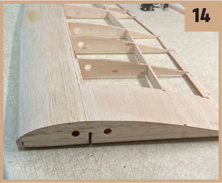 Wooden wing structure with ribs and spars; number 14 in the corner.