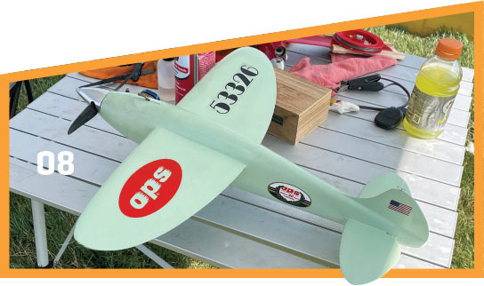 Mint green model airplane on a table, number 53326, with "aps" logo on the wing.