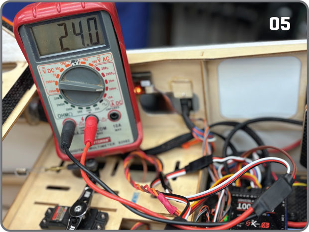Multimeter reading 24.0 in a circuit setup with wires and components.