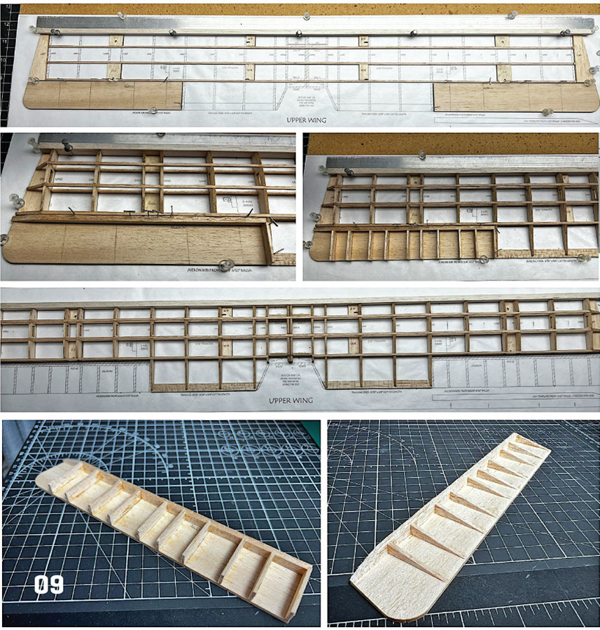 Wooden model airplane wing assembly on blueprint with grid cutting mat below.