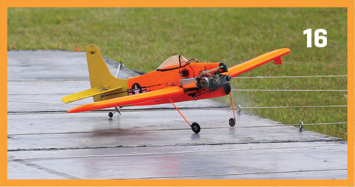 Orange and yellow model airplane on a runway, number 16 on top right.
