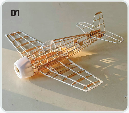 Wooden model airplane casting a shadow, labeled "01".