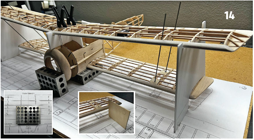 Wooden model airplane under construction on a blueprint, metal blocks for stability.