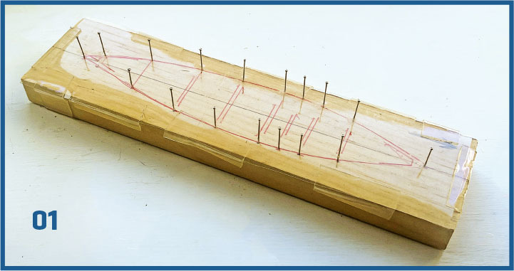 Rectangular box with red lines and protruding pins. Number 01 in blue.