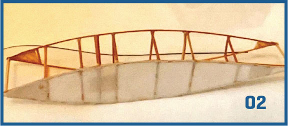 Wooden wing structure with white fabric, blue number 02.