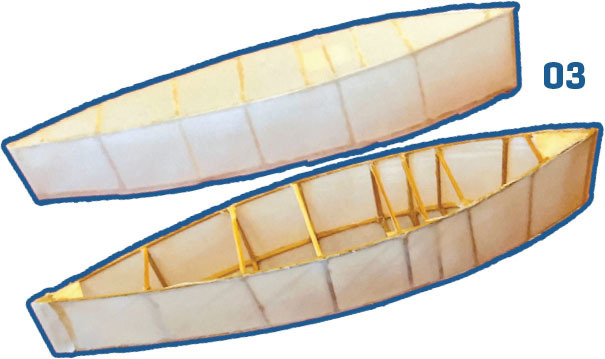 Two model boat frames with white covers, labeled "03".