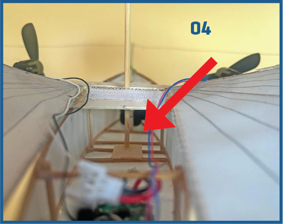 Model airplane wiring with arrow pointing, number "04" in blue.