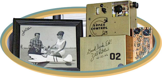 Black and white photo with a man and woman by a model plane, "Space Control" device and signature.