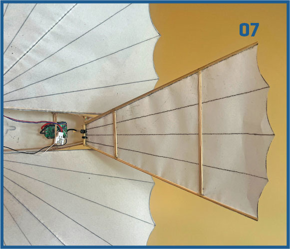 White fan-like mechanical structure with visible wiring, labeled "07".