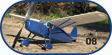 Blue model airplane on dirt, marked with "08" in black.