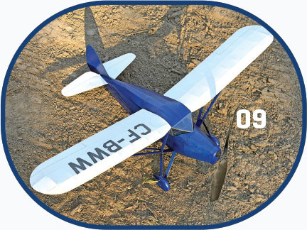 Blue and white toy airplane on sandy ground, marked CF-BWM and 09.