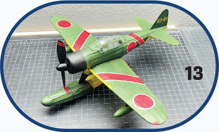 Green model airplane with red circles and number 13 nearby.