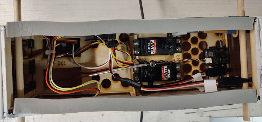 RC plane fuselage interior with wires and servos labeled HS-311.