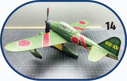Model of a green aircraft with red circles and "V2-101" text, marked "14".