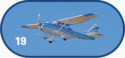 Small blue and white plane in flight, number 19 on left.