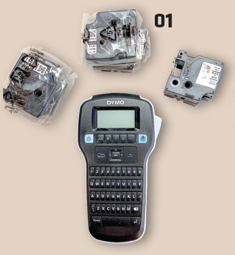 Dymo label maker with tape cartridges, labeled "01".