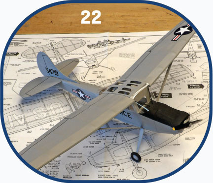 Gray model airplane on construction plans, number 22 above.