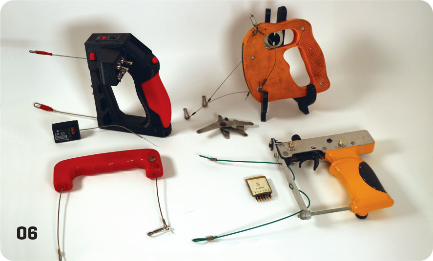 Various colorful cable tie tensioning tools on a white surface, numbered 06.