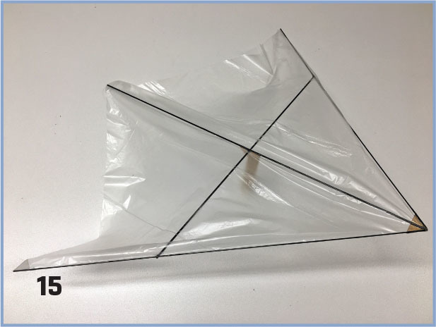 Plastic triangular sail with black lines, numbered 15.