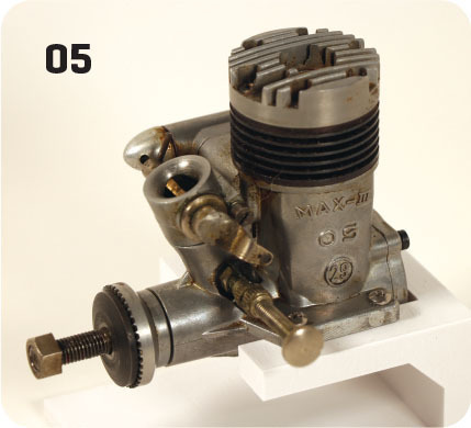 Model engine labeled "MAX-III 05" with metal details, displayed on a white stand.
