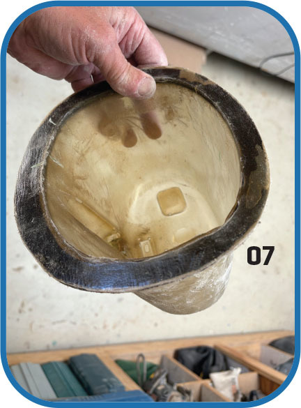 Hand holding a fiberglass mold, number 07 visible.