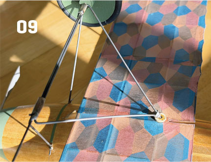 Model aircraft wing with colorful hexagonal pattern and the number 09.