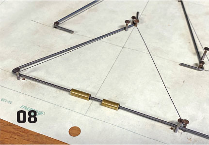 Geometric model with rods and brass fittings on grid paper, number 08.