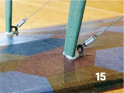 Green pole attached to a colorful base with wires, number 15 visible.