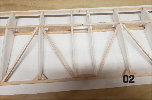 Wooden structure with a grid pattern and "02" text in the bottom right corner.