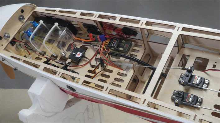 Inside view of a model aircraft showing wiring and control mechanisms.