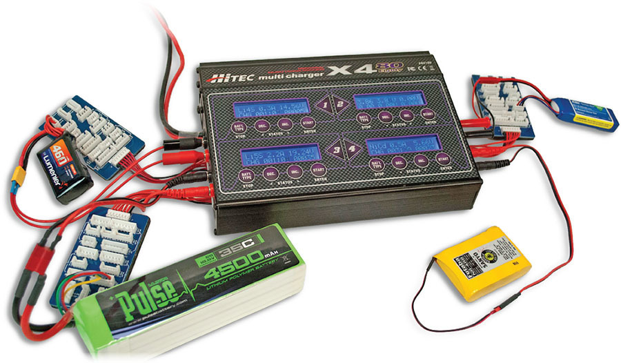 Battery charger setup with connected batteries and cables.