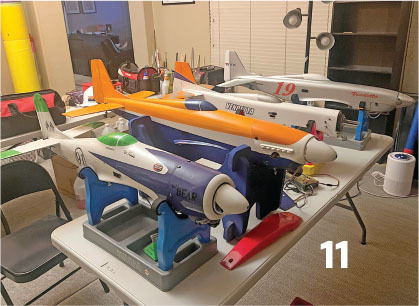 Model airplanes on a table, numbered 11 in a room setting.