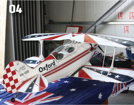 White biplane with "Oxford" on side over Australian flag.
