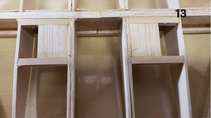 Wooden model framework with compartments and number 13 in the top right corner.