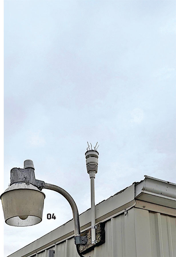 Streetlight and weather sensor on a rooftop, numbered 04.