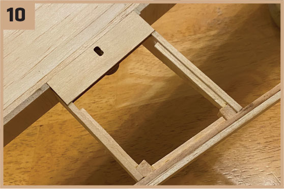 Wooden structure with a rectangular cutout, number 10 in the corner.