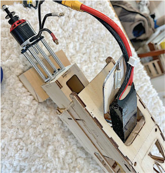 Wooden model airplane with an electric motor and wiring.
