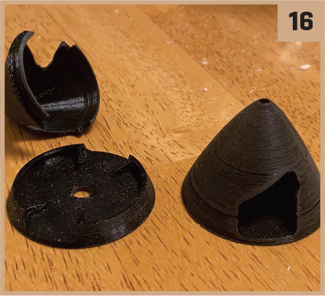 Three black 3D-printed cone parts on wooden surface, labeled 16.