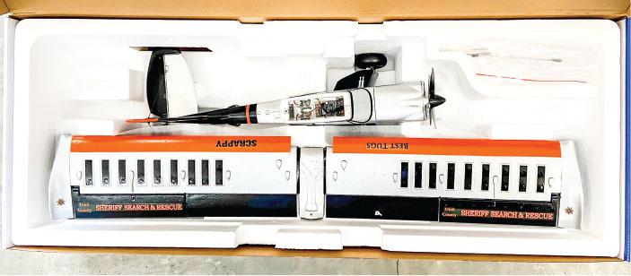 Toy plane kit with Sheriff Search & Rescue graphics in styrofoam packaging.