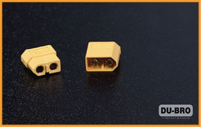 Two yellow connectors on a black surface, with "DU-BRO" logo in the corner.