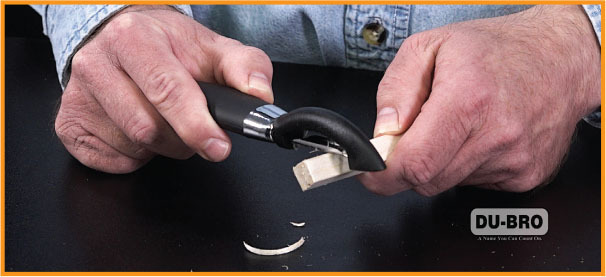 Hands carving wood with a black knife; DU-BRO logo visible.