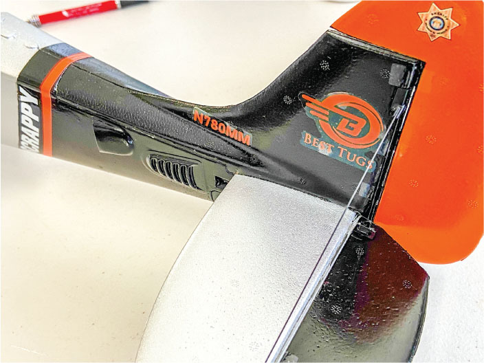 Model aircraft tail with "Best Tugs," "N780MM" text, and orange star logo.